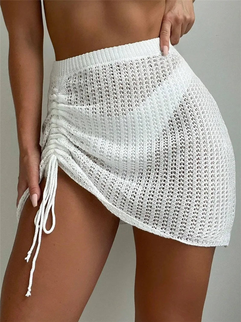 BKLD Beach Vacation Mini Skirts Knitted Hollow Out Hip Hugging Drawstring Sexy Perspective Skirts 2026 Summer Women Clothing